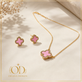 Pink Clover Necklace and Earrings Set with Ohana Design branding - gold chain and pink clover pendant with matching stud earrings on cream background