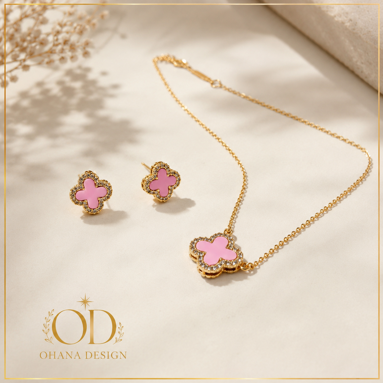 Pink Clover Necklace and Earrings Set with Ohana Design branding - gold chain and pink clover pendant with matching stud earrings on cream background